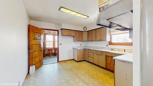 4734 W Palmer St, Chicago, IL 60639 - kitchen with light countertops, light floors, under cabinet range hood, a sink, and a wealth of natural light