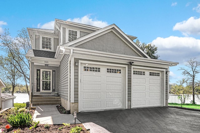 934 Robertson Rd, South Elgin, IL 60177 - view of front facade featuring entry steps, asphalt driveway, and an attached garage