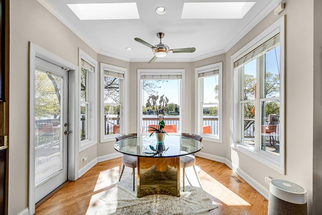 934 Robertson Rd, South Elgin, IL 60177 - sunroom with a skylight, crown molding, healthy amount of natural light, wood finished floors, and recessed lighting