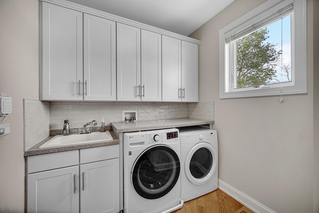 934 Robertson Rd, South Elgin, IL 60177 - laundry area with washer and clothes dryer, cabinet space, baseboards, and light wood-type flooring
