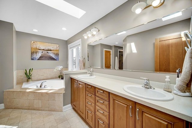 934 Robertson Rd, South Elgin, IL 60177 - full bathroom featuring a skylight, double vanity, a whirlpool tub, tile patterned floors, and baseboards