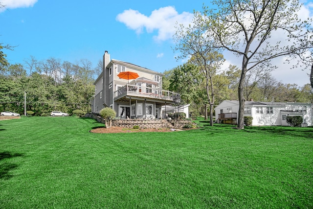 934 Robertson Rd, South Elgin, IL 60177 - rear view of house featuring a chimney, a deck, and a lawn