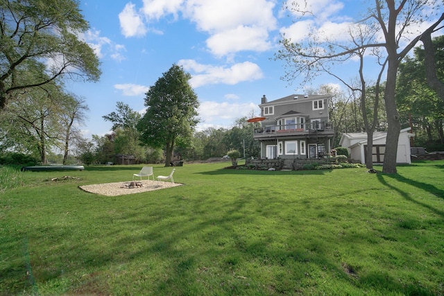 934 Robertson Rd, South Elgin, IL 60177 - view of grassy yard featuring a fire pit, a wooden deck, and a storage shed