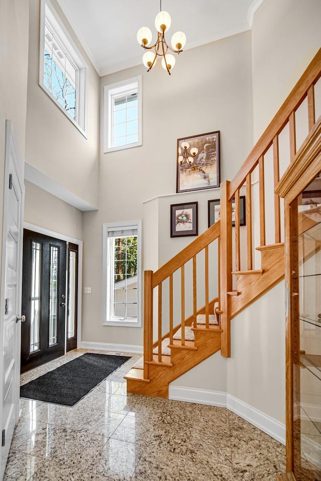 934 Robertson Rd, South Elgin, IL 60177 - entryway featuring granite floors, a chandelier, plenty of natural light, stairway, and crown molding