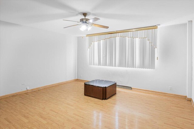 5817 W 16th St, Cicero, IL 60804 - empty room with visible vents, baseboards, ceiling fan, and wood finished floors