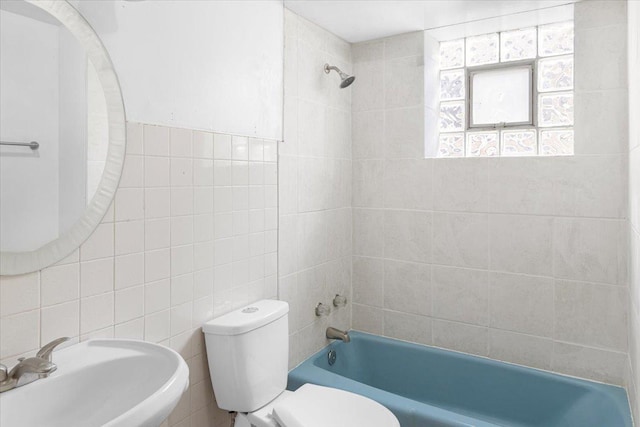 5817 W 16th St, Cicero, IL 60804 - bathroom featuring toilet, a sink, bathtub / shower combination, and tile walls
