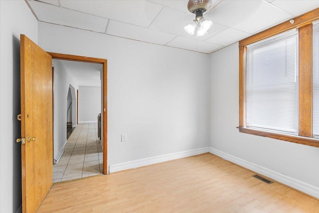 5817 W 16th St, Cicero, IL 60804 - unfurnished room with baseboards, visible vents, light wood-style flooring, and a paneled ceiling
