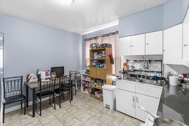5817 W 16th St, Cicero, IL 60804 - kitchen with decorative backsplash, white cabinetry, a sink, and light tile patterned flooring