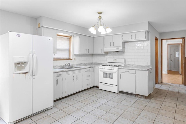 5817 W 16th St, Cicero, IL 60804 - kitchen with light countertops, white appliances, under cabinet range hood, a sink, and backsplash