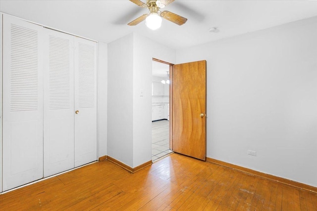 5817 W 16th St, Cicero, IL 60804 - unfurnished bedroom with a closet, ceiling fan, baseboards, and hardwood / wood-style flooring