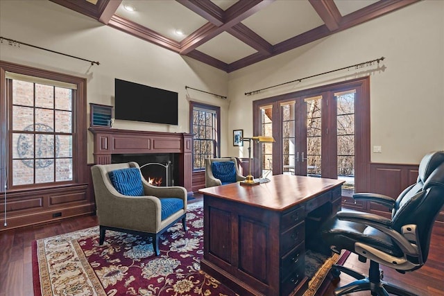 office space with coffered ceiling, beamed ceiling, dark wood finished floors, and a wainscoted wall