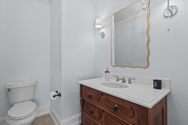 bathroom featuring baseboards, toilet, tile patterned flooring, and vanity