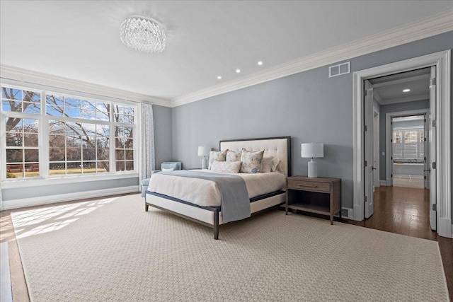 bedroom featuring wood finished floors, baseboards, visible vents, ornamental molding, and recessed lighting