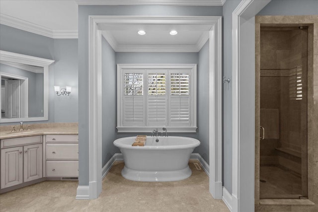 full bathroom featuring crown molding, baseboards, a freestanding tub, vanity, and a stall shower