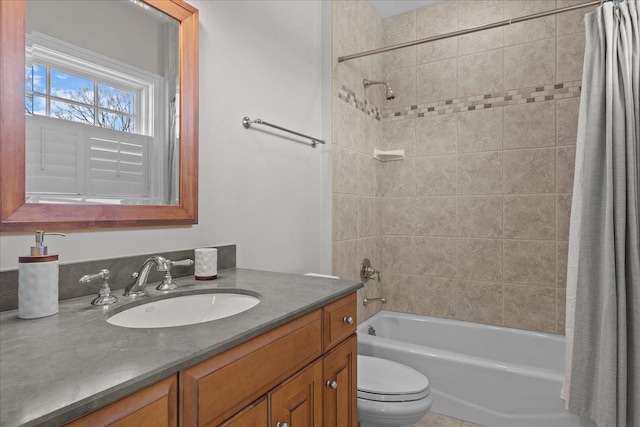 bathroom featuring toilet, shower / tub combo with curtain, and vanity