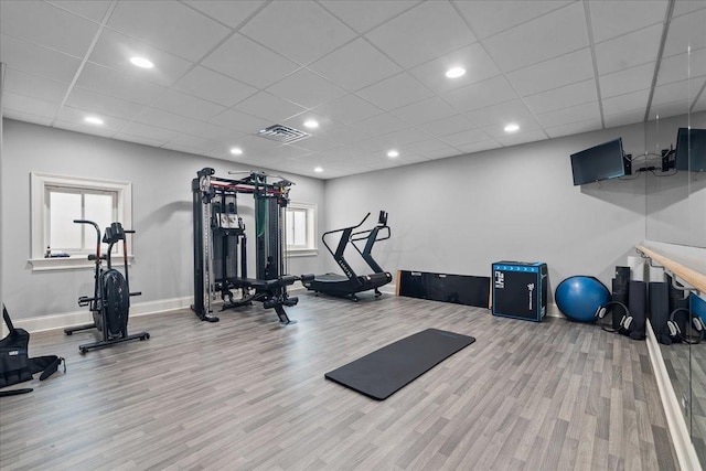 exercise room with baseboards, visible vents, recessed lighting, and wood finished floors