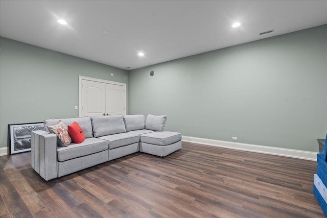 living area with dark wood finished floors, baseboards, visible vents, and recessed lighting
