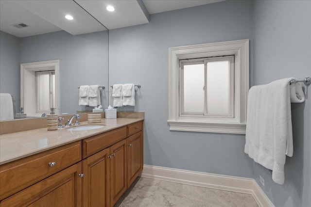 bathroom featuring baseboards, visible vents, recessed lighting, and vanity
