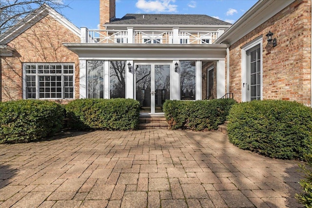 view of patio with french doors and a balcony