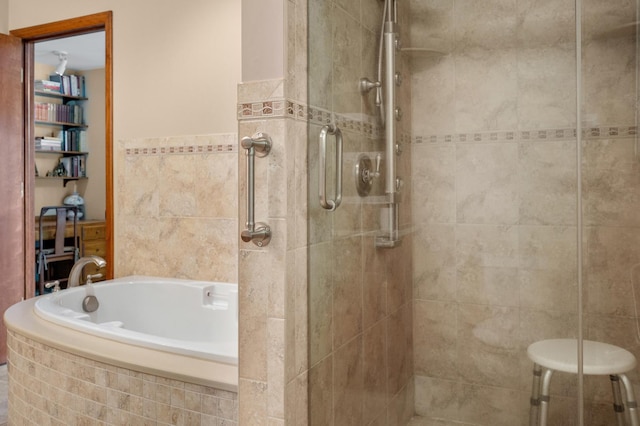 full bath featuring a shower stall and a garden tub