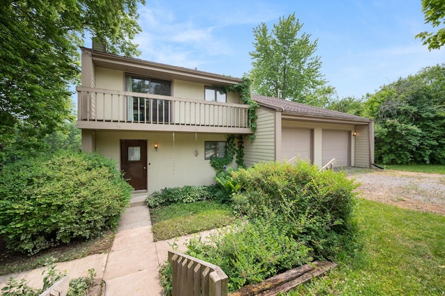 view of front of property featuring stucco siding, a balcony, and an attached garage