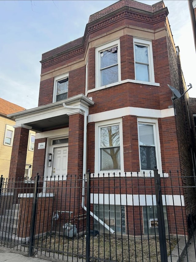 5121 S Loomis Blvd, Chicago, IL 60609 - view of property with brick siding and a fenced front yard