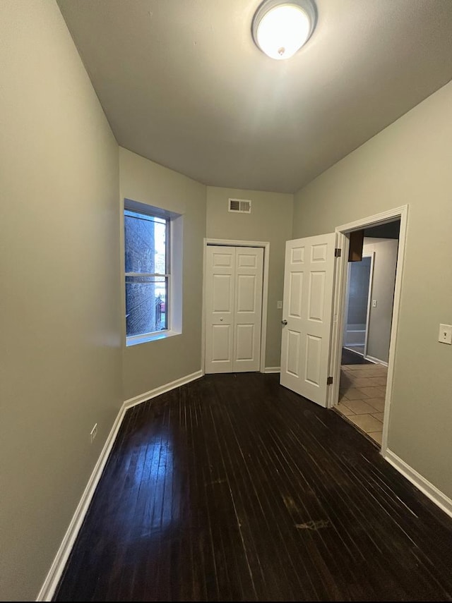 5121 S Loomis Blvd, Chicago, IL 60609 - unfurnished bedroom with hardwood / wood-style flooring, baseboards, visible vents, and a closet
