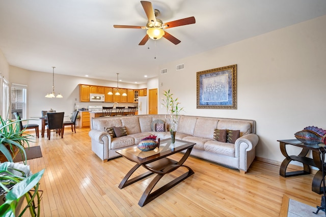 living room with visible vents, ceiling fan, light wood finished floors, and recessed lighting