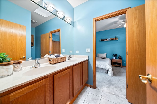 bathroom with tile patterned floors, double vanity, a sink, and connected bathroom
