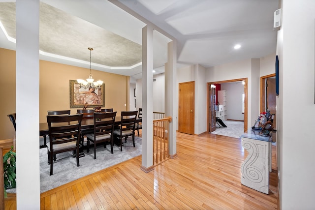 dining room featuring a notable chandelier and light wood-style flooring
