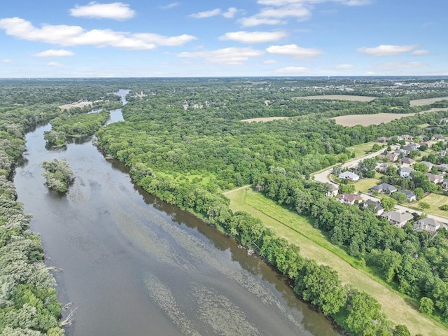 birds eye view of property with a view of trees and a water view