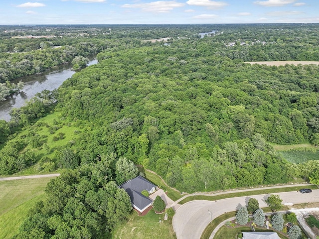 birds eye view of property with a water view and a view of trees