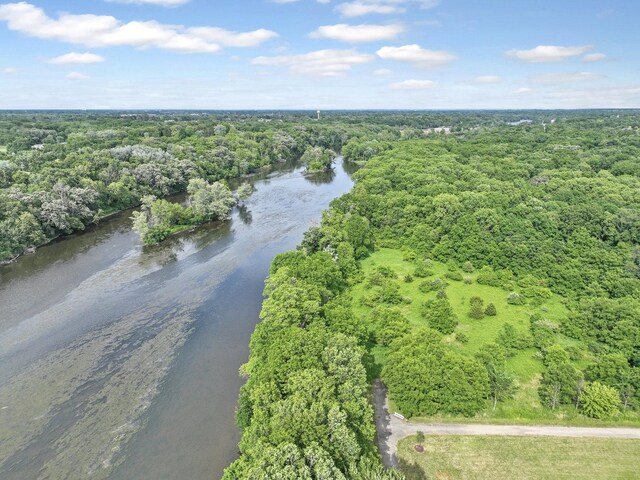 aerial view with a forest view and a water view
