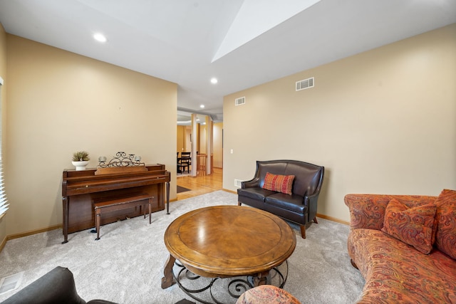 carpeted living room featuring recessed lighting, visible vents, baseboards, and lofted ceiling