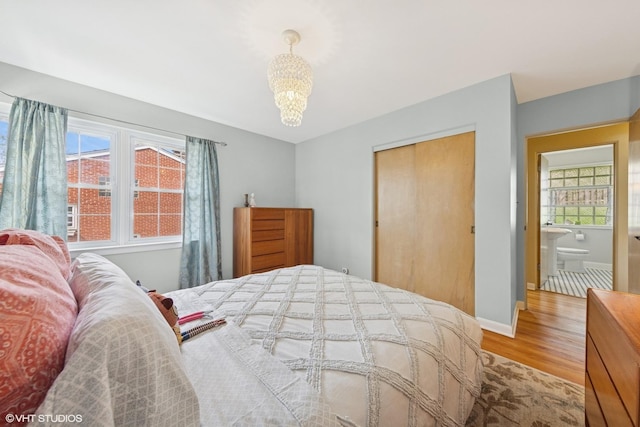 807 Webster Ave, Wheaton, IL 60187 - bedroom featuring a closet, wood finished floors, a chandelier, and multiple windows
