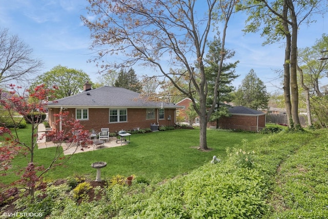 807 Webster Ave, Wheaton, IL 60187 - rear view of property featuring fence, a chimney, brick siding, a patio area, and a lawn