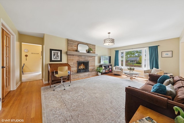 807 Webster Ave, Wheaton, IL 60187 - living area with a stone fireplace, light wood finished floors, and baseboards