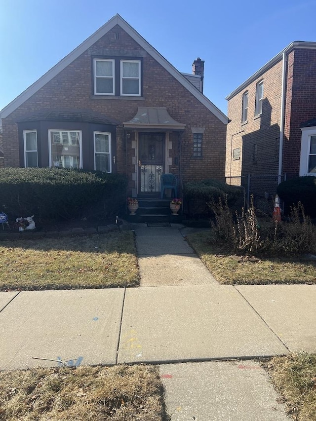 607 E 103rd Pl, Chicago, IL 60628 - view of front of home featuring a chimney and brick siding