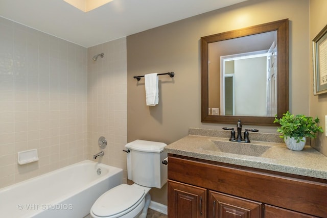bathroom featuring toilet, shower / bathing tub combination, and vanity