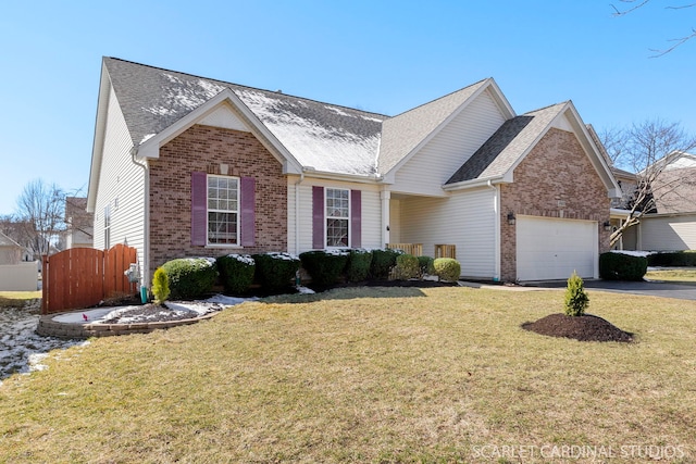 ranch-style home featuring an attached garage, a front yard, brick siding, driveway, and a shingled roof