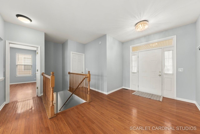 entryway with hardwood / wood-style floors and baseboards