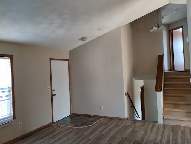 interior space with baseboards and wood finished floors