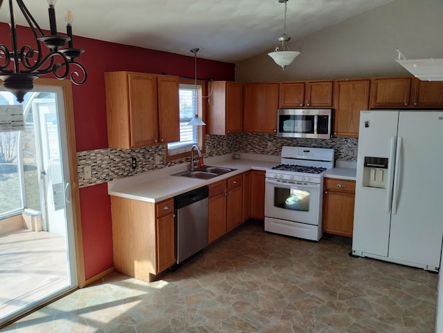 kitchen featuring light countertops, a sink, a notable chandelier, and appliances with stainless steel finishes