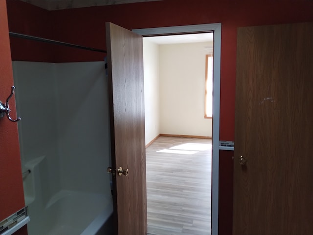 bathroom featuring baseboards and wood finished floors
