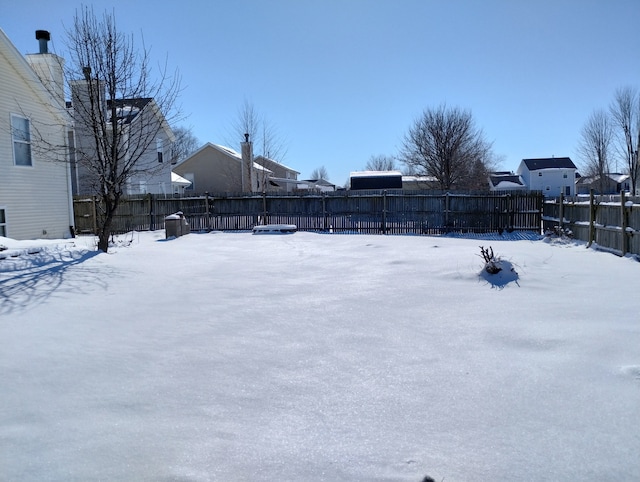 yard layered in snow with fence