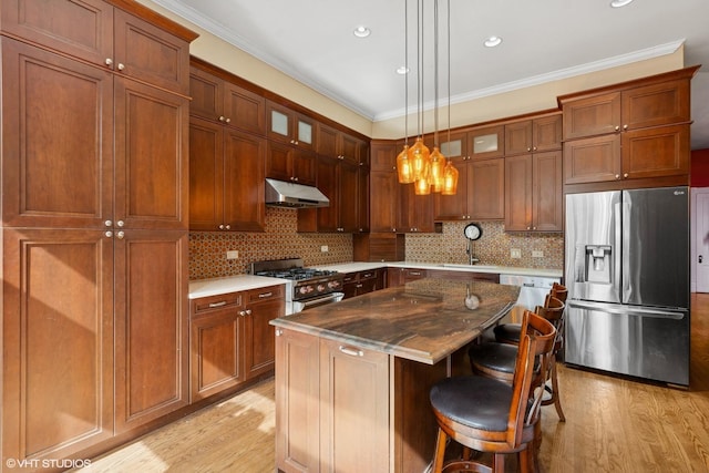 1957 W Schiller St, Chicago, IL 60622 - kitchen with stainless steel appliances, under cabinet range hood, light wood-type flooring, glass insert cabinets, and a center island