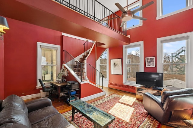 1957 W Schiller St, Chicago, IL 60622 - living room featuring wood finished floors, stairway, a ceiling fan, an office area, and a high ceiling