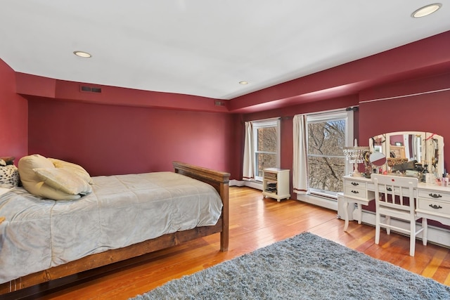 1957 W Schiller St, Chicago, IL 60622 - bedroom with wood finished floors, recessed lighting, and a baseboard heating unit