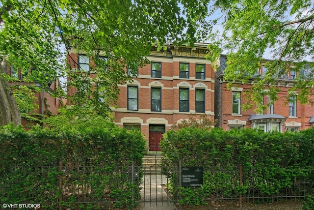 1957 W Schiller St, Chicago, IL 60622 - view of property featuring brick siding, a fenced front yard, and a gate
