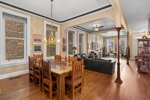 1957 W Schiller St, Chicago, IL 60622 - dining area featuring wood finished floors, ornamental molding, a ceiling fan, a chandelier, and arched walkways